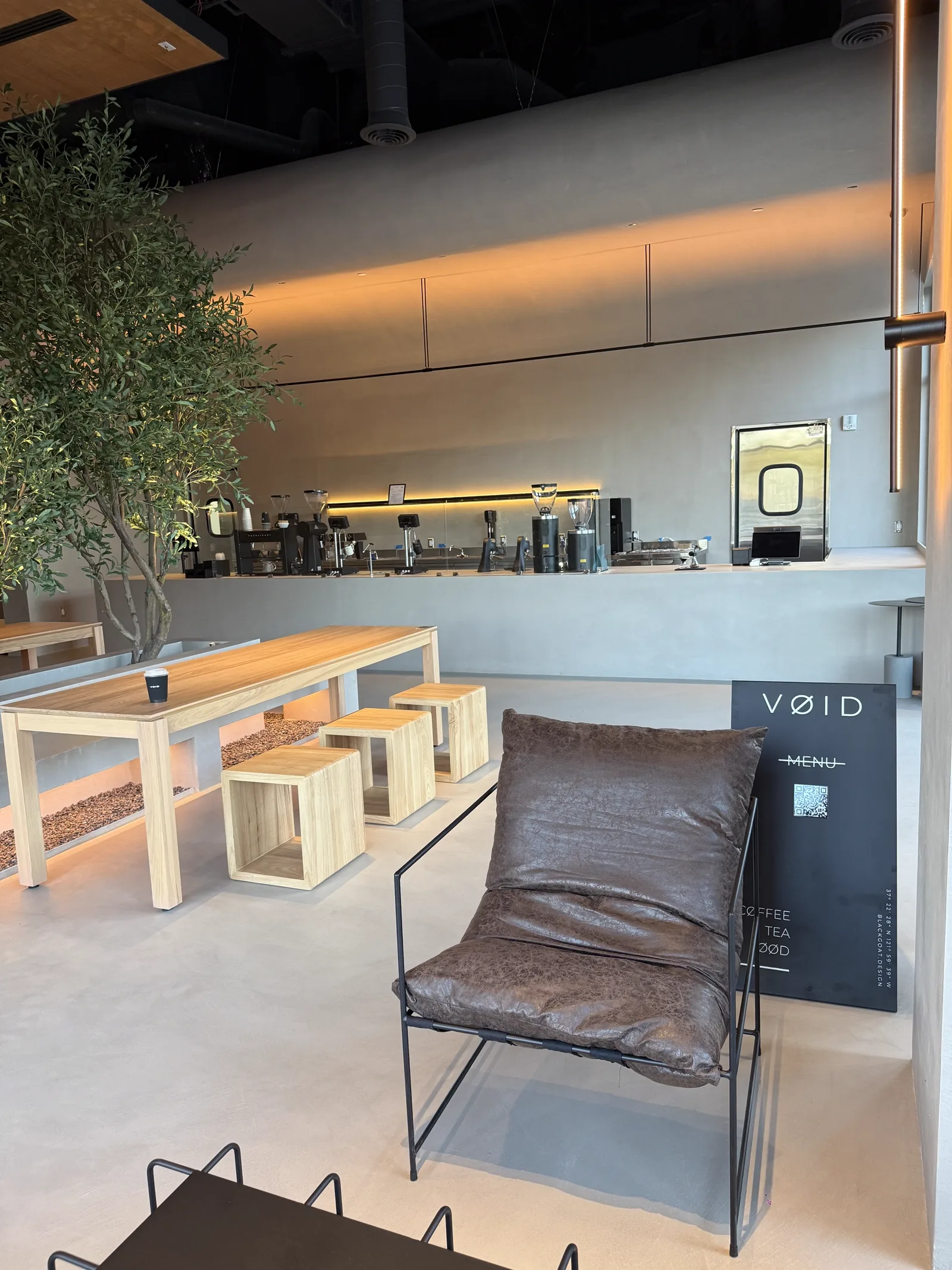 Leather lounge chair beside the VOID menu board